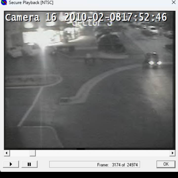 (Image 1) Camera 16 — 17:52:46. A woman and two young children walking toward the camera, away from the crosswalk that leads to the parking area where the abandoned Isuzu Trooper was later found.