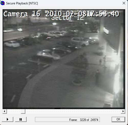 (Image 5) Camera 16 — 17:53:40. All four together, walking away from the camera in front of the duty-free store. One of the children has turned around, hands raised, toward the adult male who has caught up.