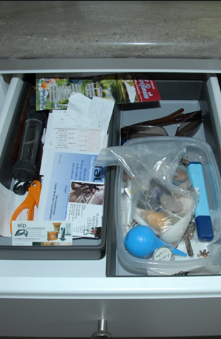 Trial Exhibit 49 — a kitchen island drawer in the same kitchen; along the left side, a second black light of the same type, stored among household items